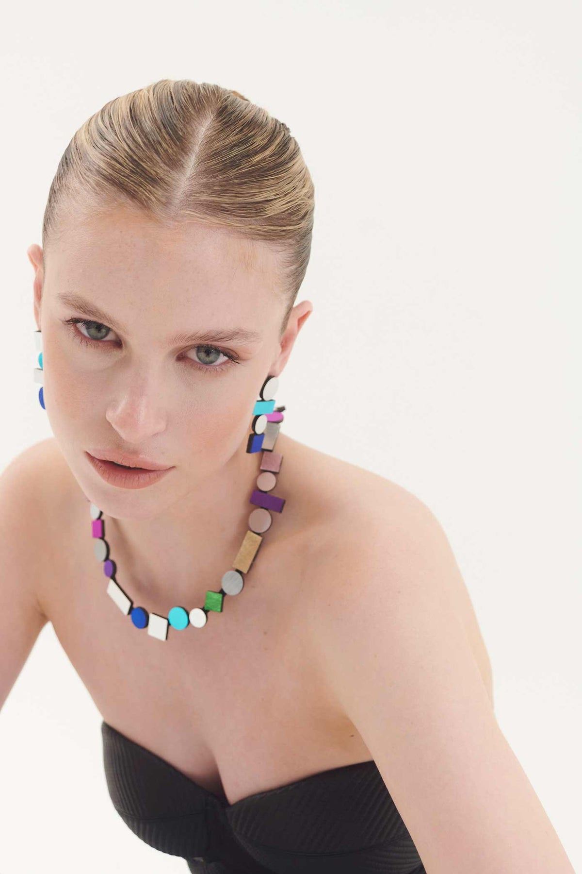 Contemporary rainbow round bib necklace in acrylic and suede, handmade by Iskin Sisters, Argentina