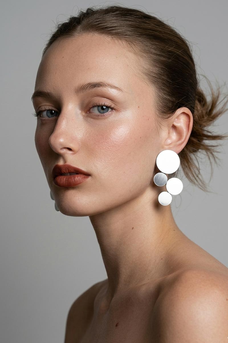 Small circular silver clip-on earrings from the Abstraction collection, Iskin Sisters