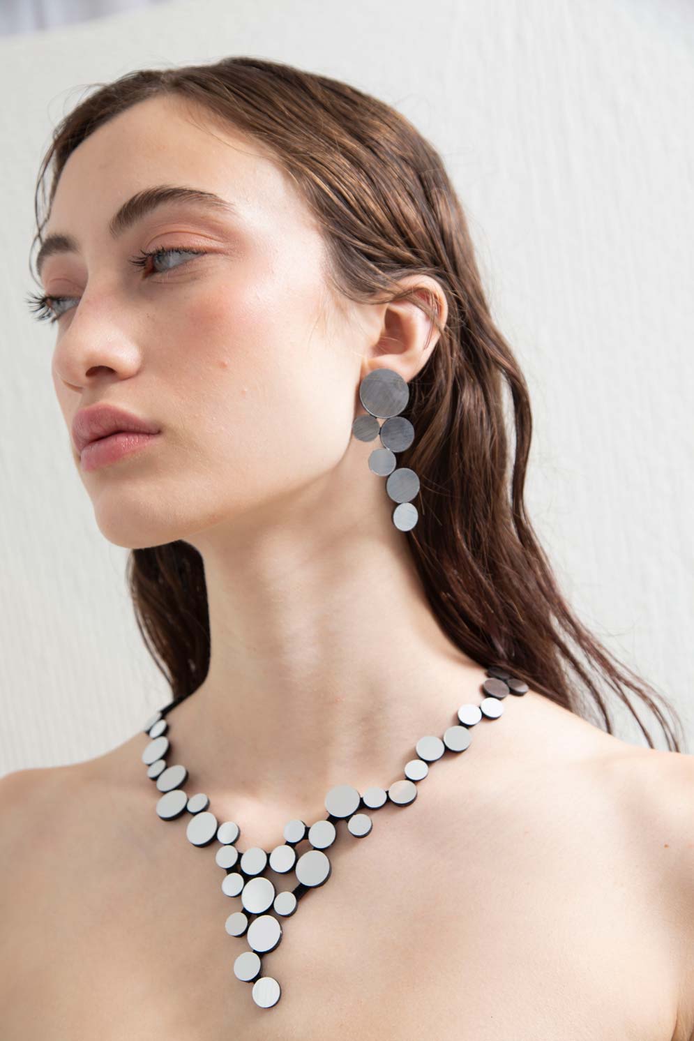 Silver metallic acrylic V-shaped bib necklace from the Abstraction collection by Iskin Sisters