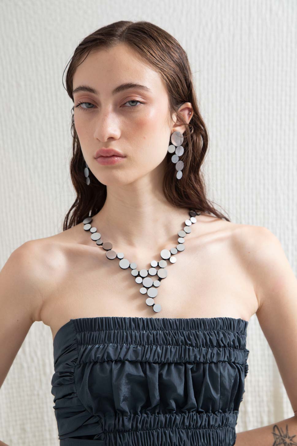 Contemporary small V necklace in silver acrylic and suede, handmade by Iskin Sisters in Buenos Aires