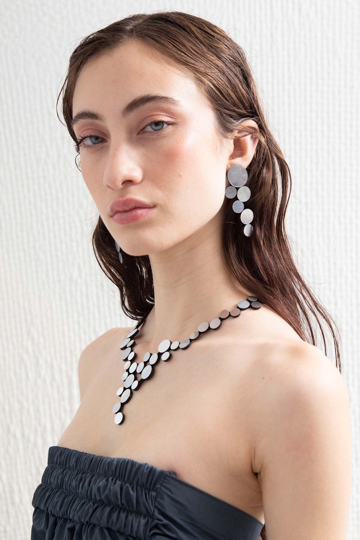 Contemporary large silver earrings in metallic acrylic and suede, handmade by Iskin Sisters