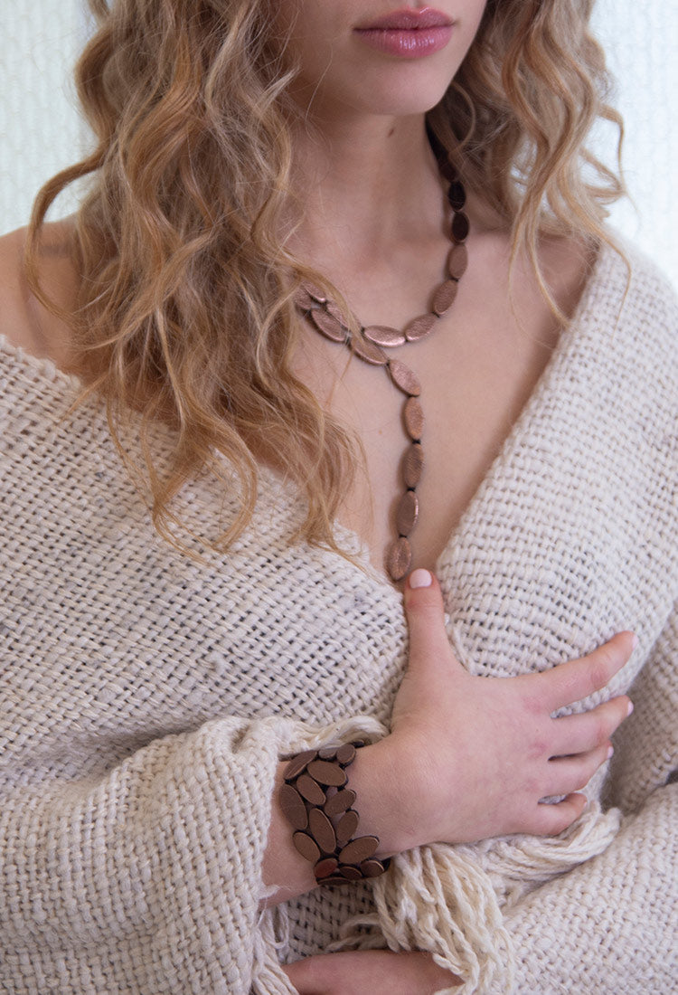 Emma Y Necklace in bronze leather with an elongated organic silhouette. It features a magnetic clasp and it's lightweight