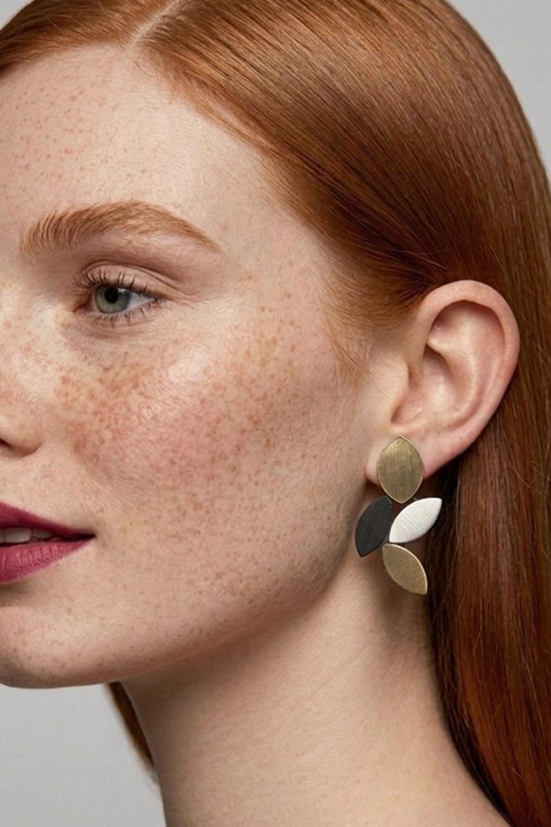 Leaf-shaped clip-on earrings in black and gold, handmade in our Buenos Aires atelier