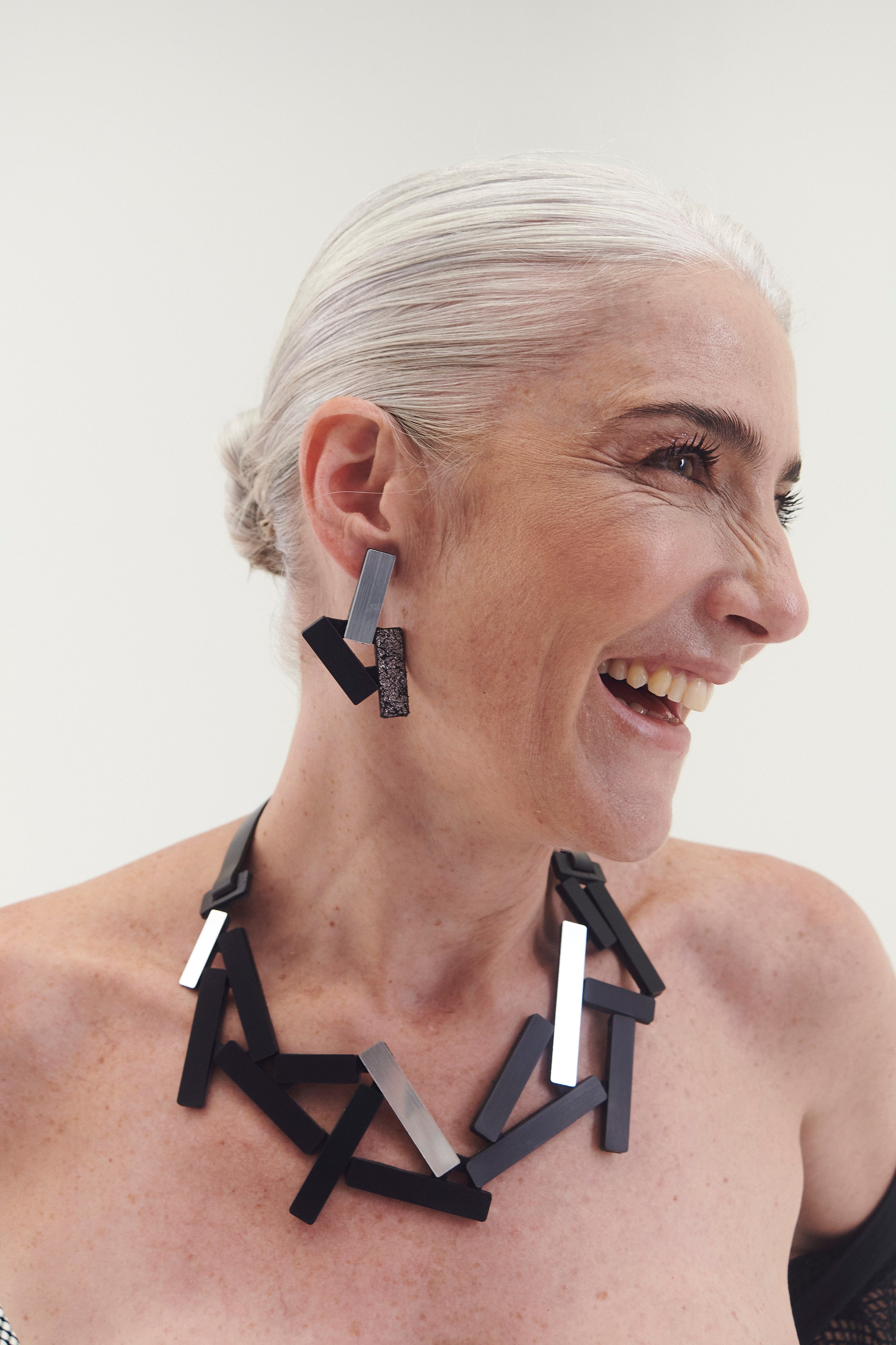Handmade Ray large necklace in silver and black acrylic on leather, designed by Iskin Sisters
