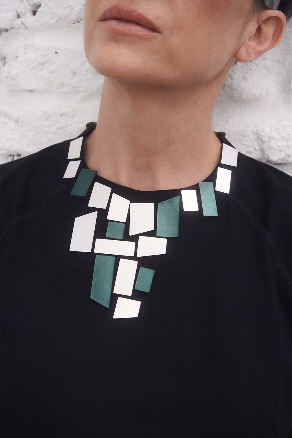 Detail of the Piet V necklace in silver and green acrylic, Iskin Sisters