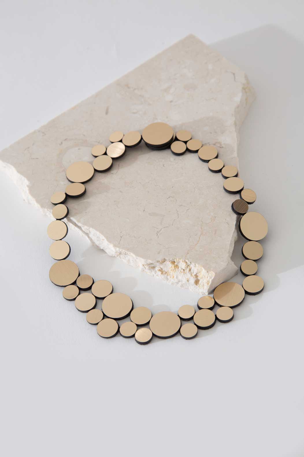 Statement small bib necklace in gold metallic acrylic by Iskin Sisters, made in Buenos Aires
