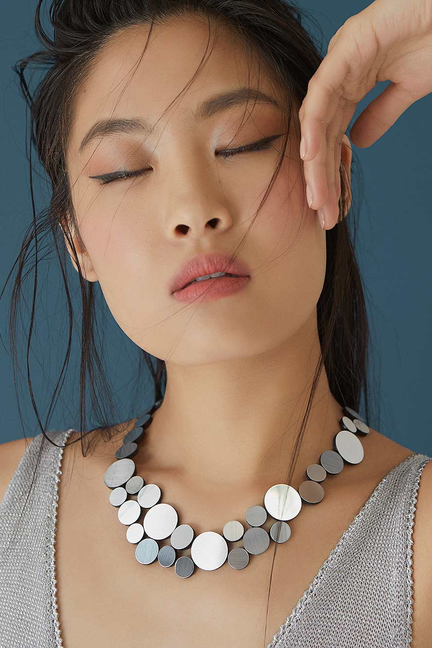 Contemporary small round necklace in silver acrylic and suede, handmade by Iskin Sisters, Argentina
