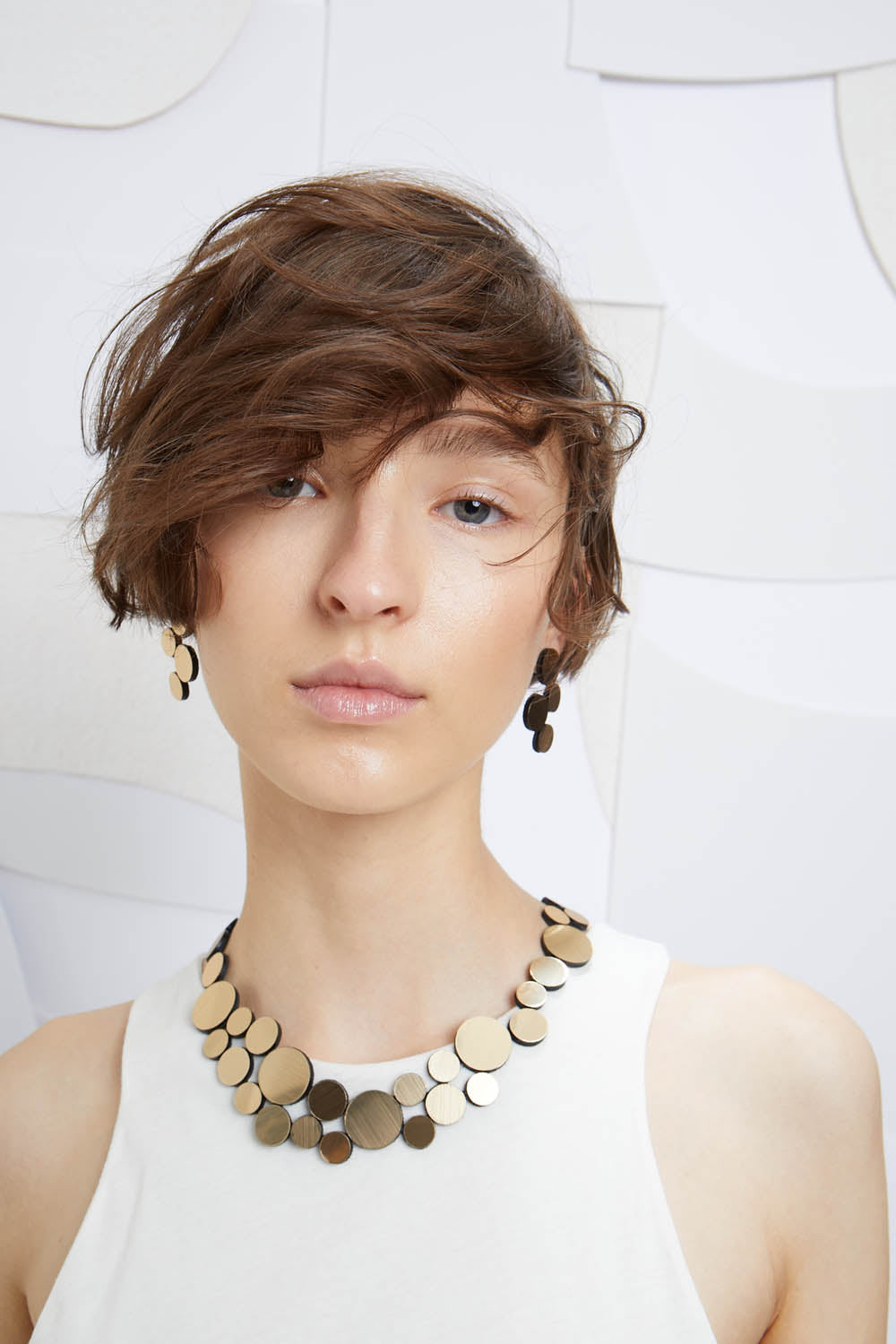 Gold metallic acrylic small bib necklace from the Abstraction collection by Iskin Sisters, Argentina
