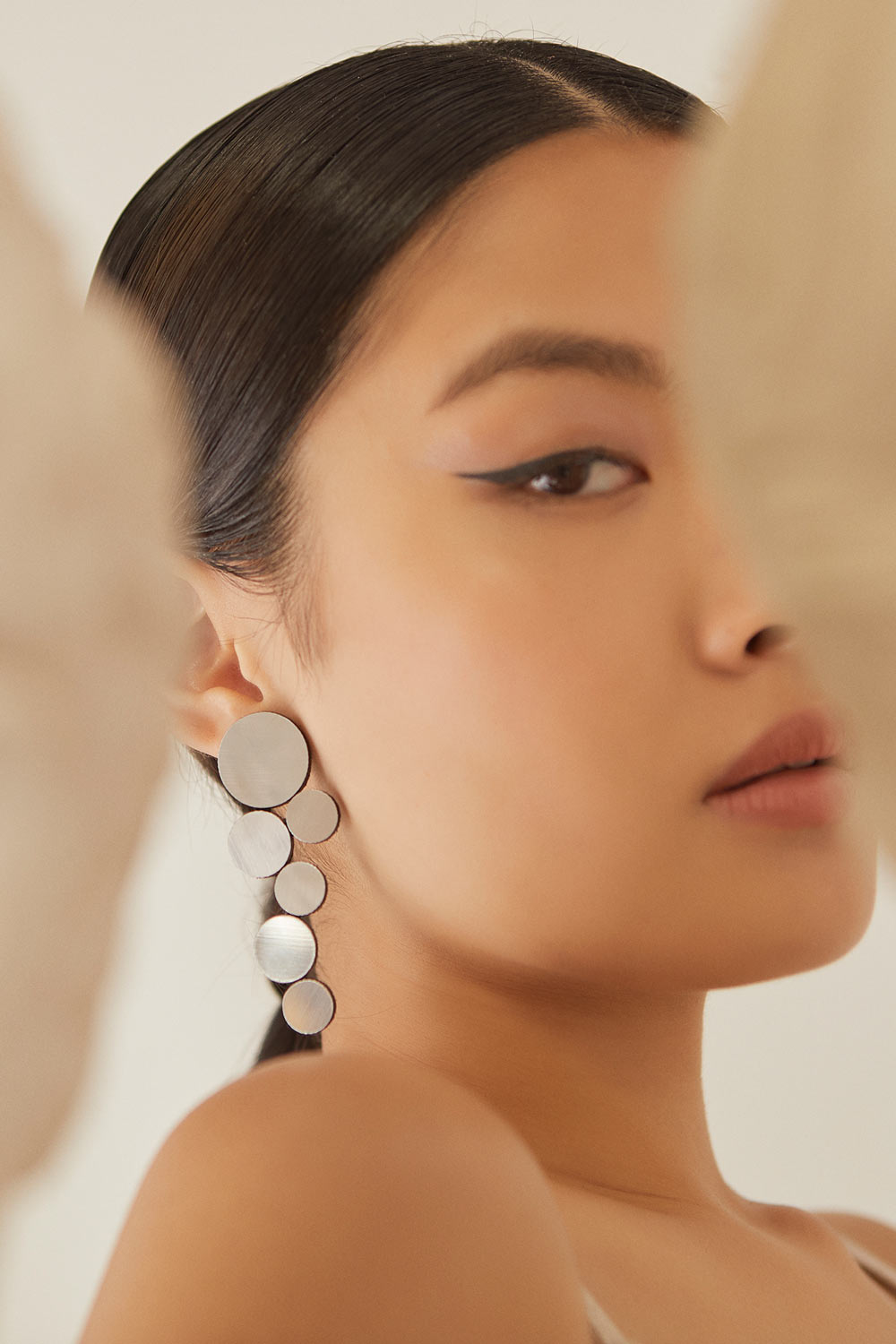 Large circular silver clip-on earrings from the Abstraction collection by Iskin Sisters