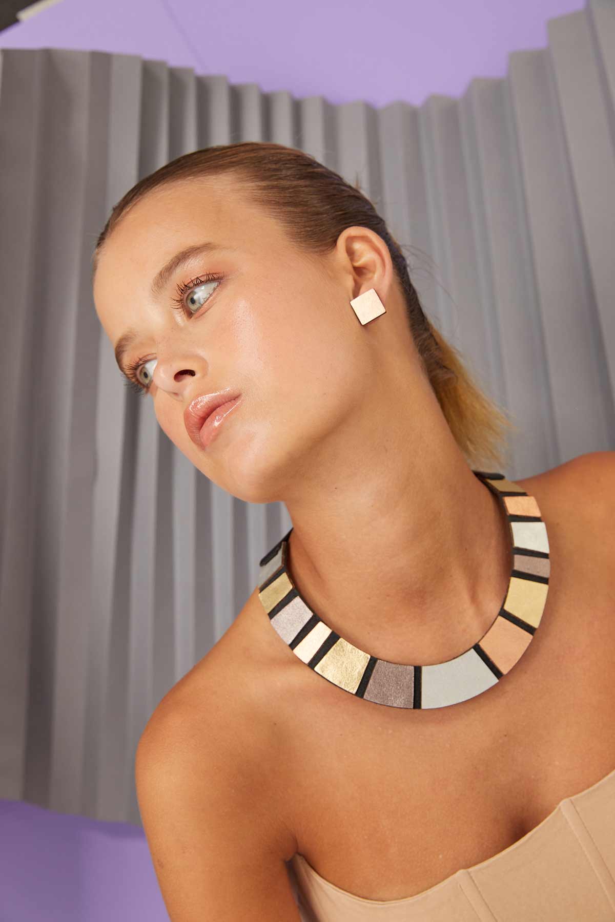 Statement round necklace in metallic hand-cut leather by Iskin Sisters, made in Buenos Aires