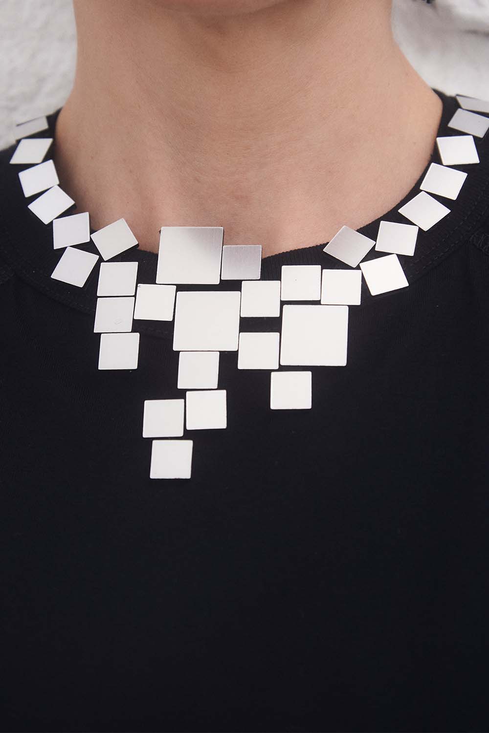 Contemporary V bib necklace in silver acrylic and leather, handmade by Iskin Sisters, Argentina
