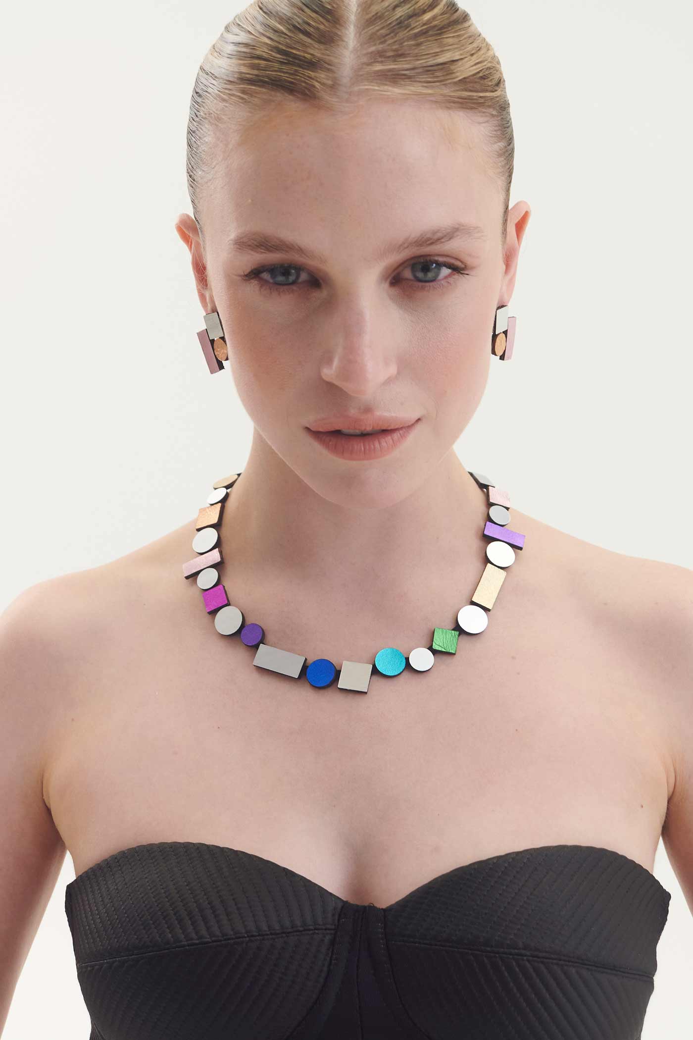Slow-fashion rainbow Bauhaus bib necklace in painted acrylic and suede by Iskin Sisters, Argentina
