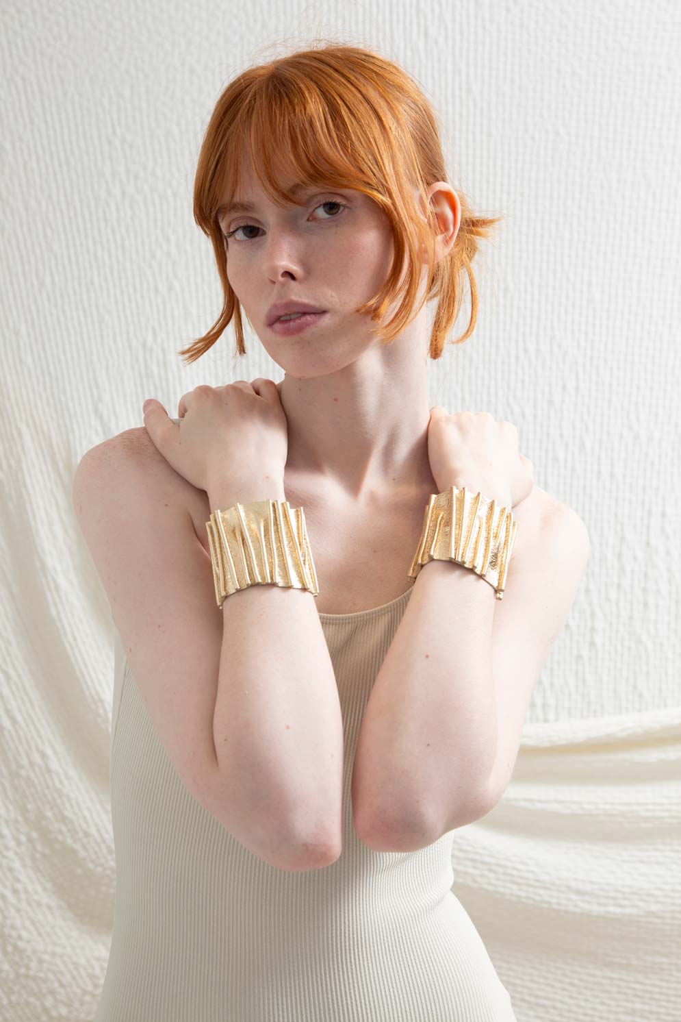 Gold acrylic stitched cuff bracelet with snap closure from the Bauhaus collection by Iskin Sisters