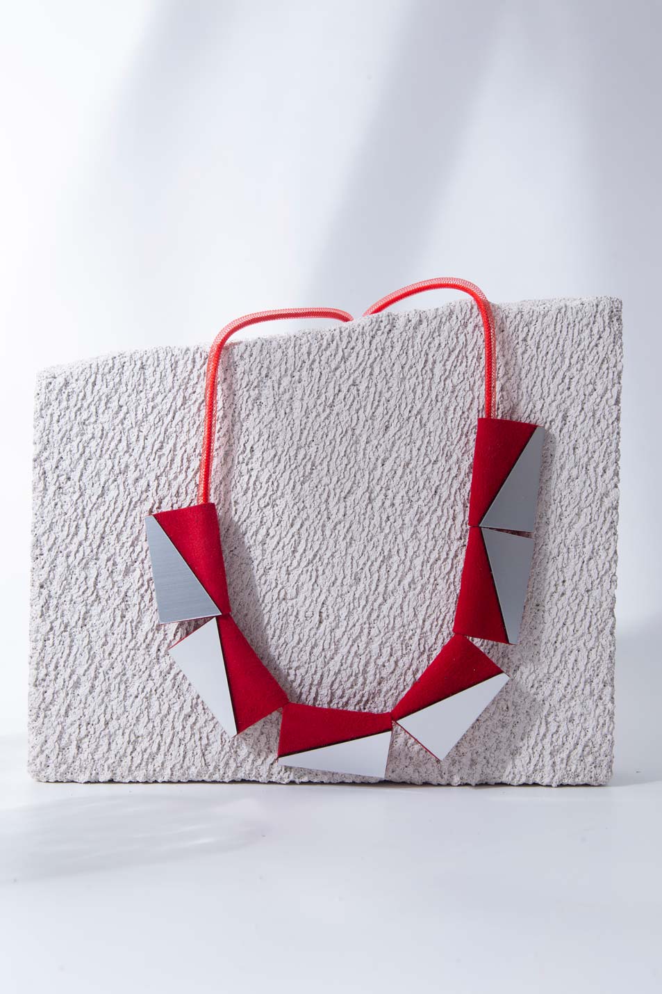Carnival Rectangles Necklace in silver acrylic and red suede with an adjustable mesh cord, a handmade piece of contemporary jewelry