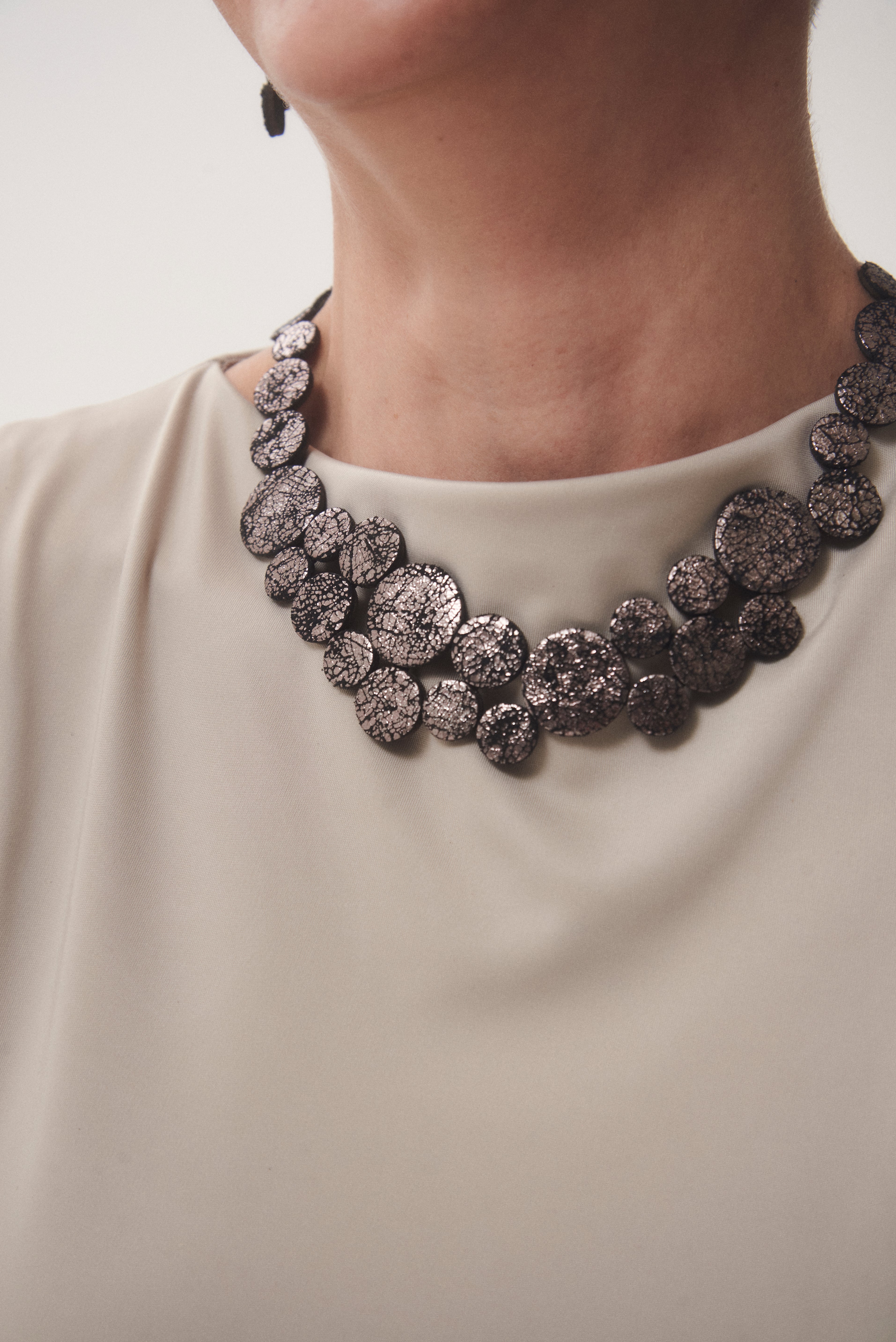 Contemporary pewter leather round necklace with acrylic, handmade by Iskin Sisters in Argentina
