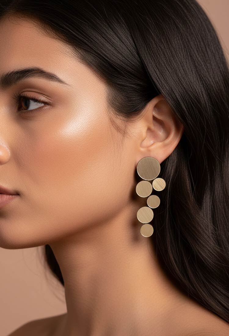 Large circular gold clip-on earrings from the Abstraction collection by Iskin Sisters