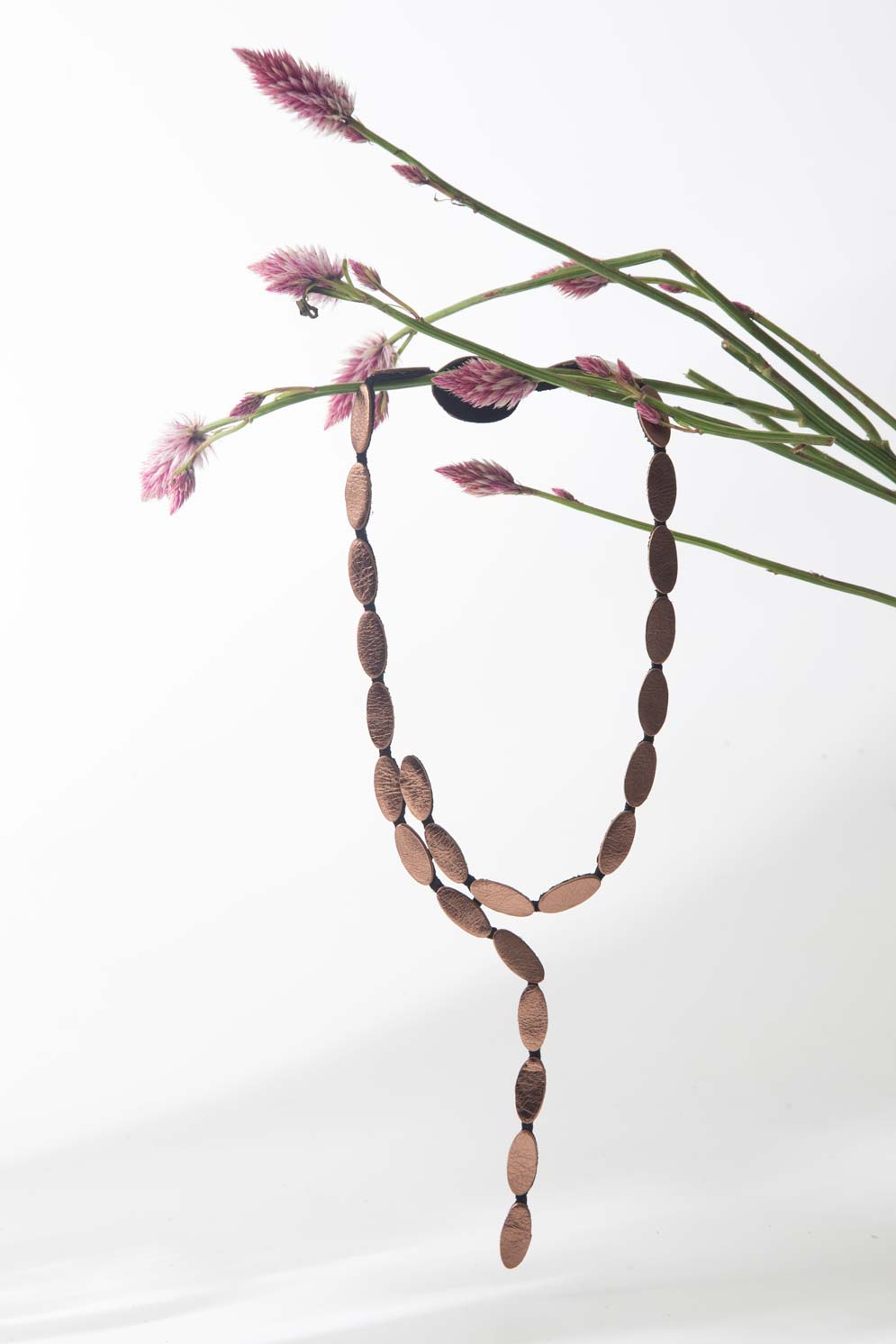 Emma Y Necklace in bronze leather with an elongated organic silhouette. It features a magnetic clasp and it's lightweight