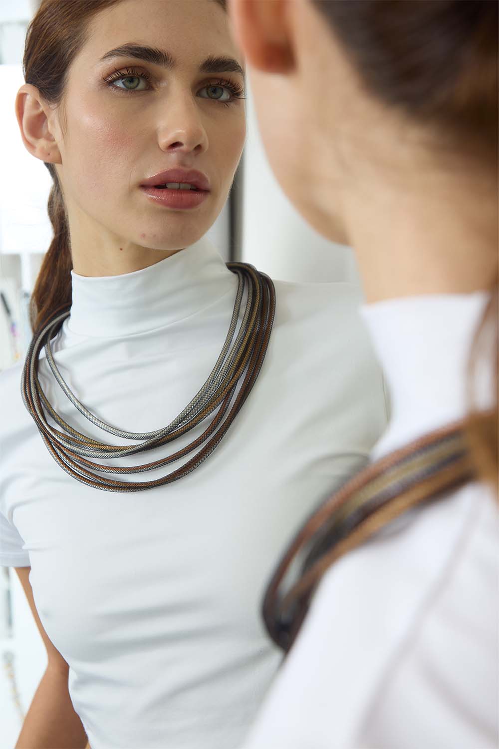 Contemporary woven cord bib necklace in metallic tones, handmade by Iskin Sisters in Argentina