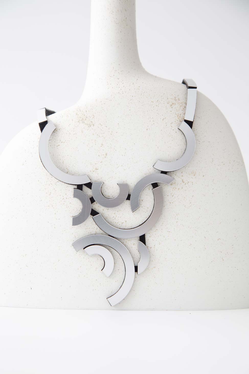 Handmade Mies Orbit necklace in silver acrylic, made in our Buenos Aires atelier