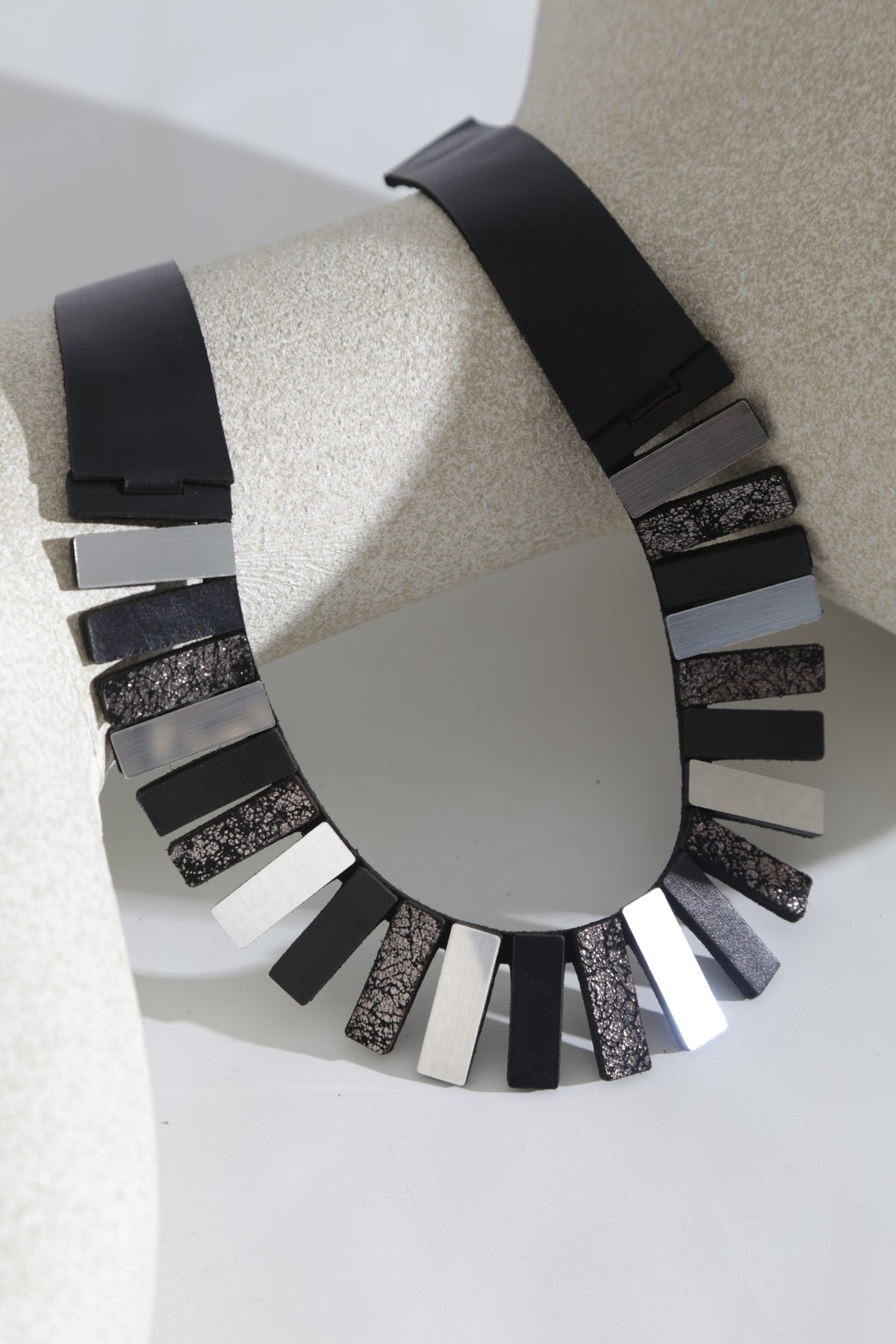 Egyptian-inspired collar necklace in silver, black and pewter acrylic and leather