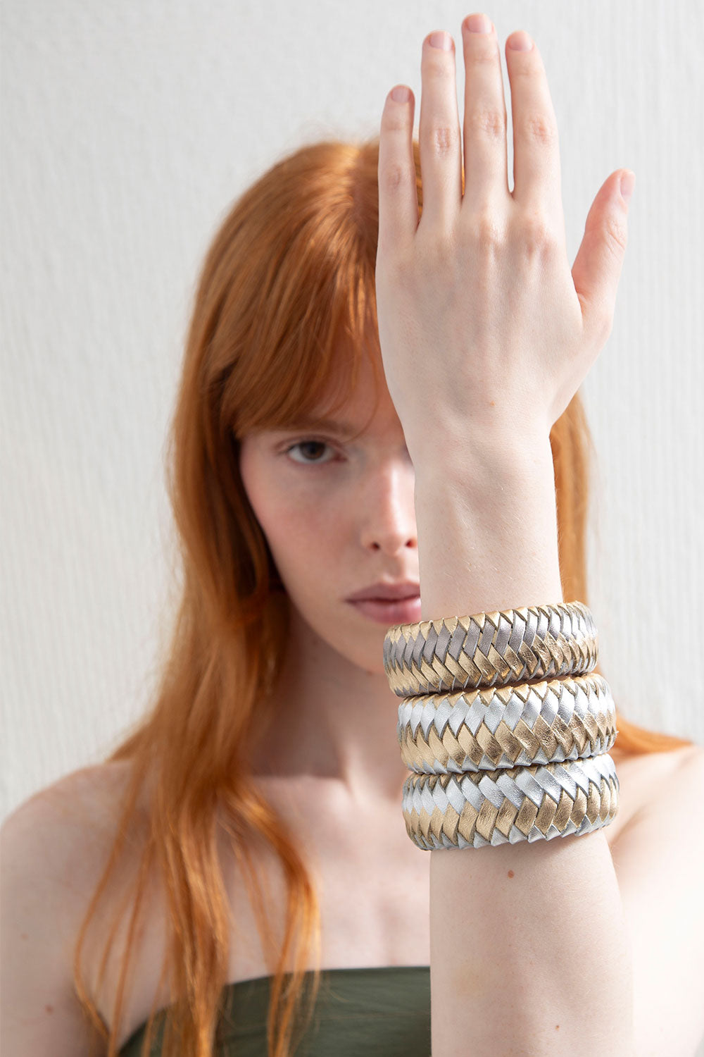 Contemporary woven leather bracelet in silver and gold, handmade by Iskin Sisters in Buenos Aires