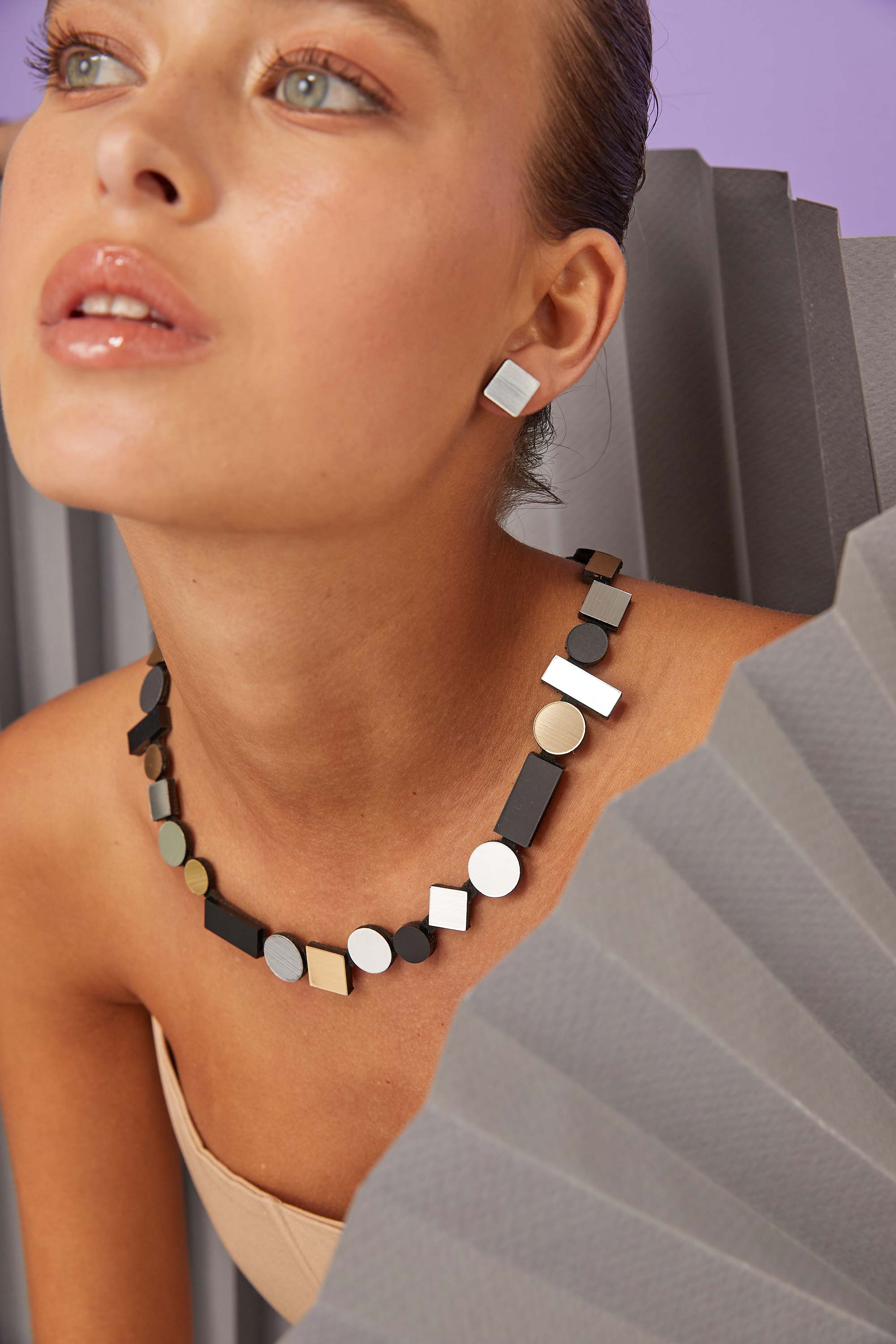 Bauhaus Necklace Round by Iskin Sisters in silver, black and gold metallic acrylic and suede