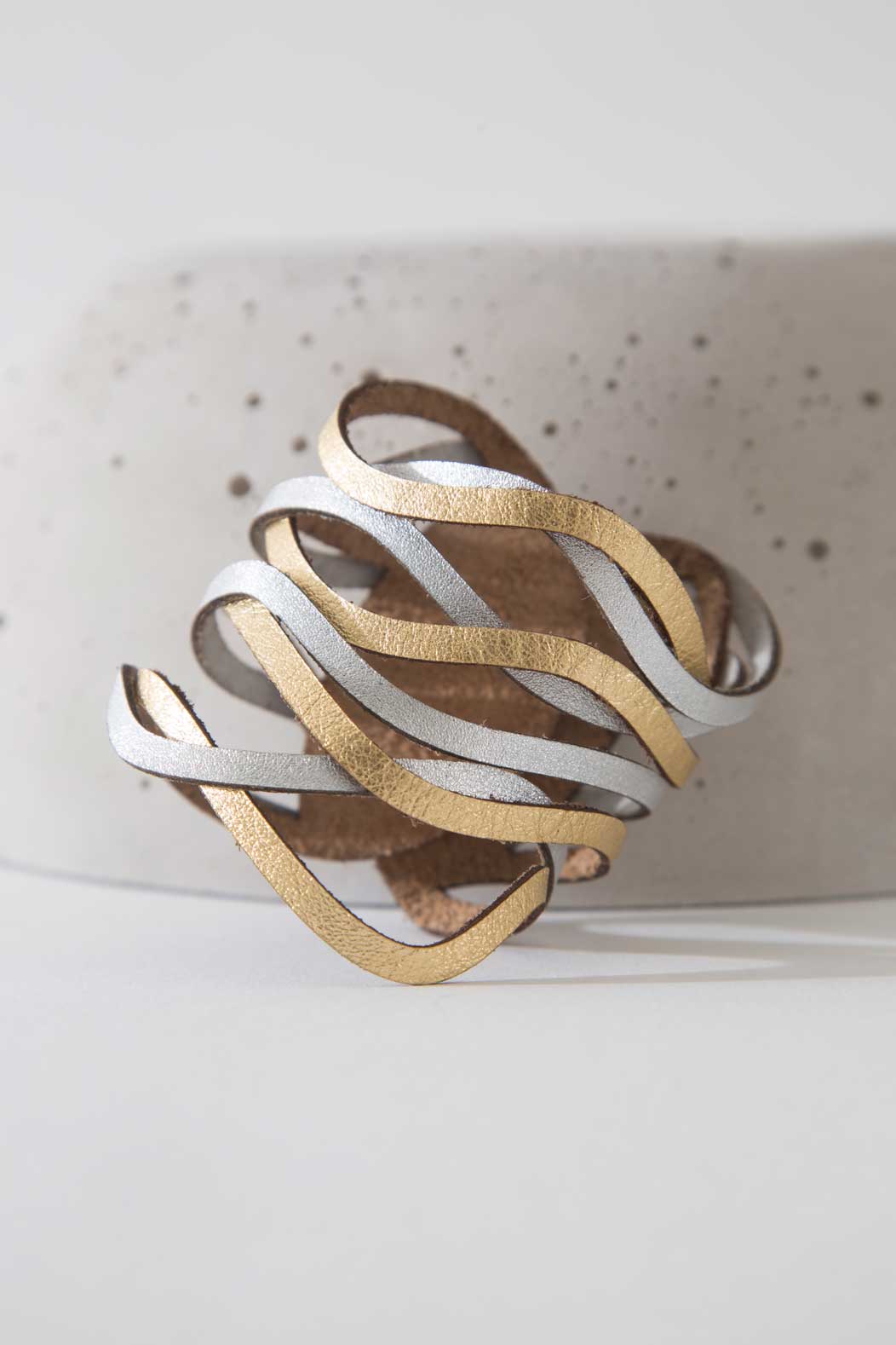 Curves Duo Cuff Bracelet by Iskin Sisters in silver and gold hand-cut leather with snap closure